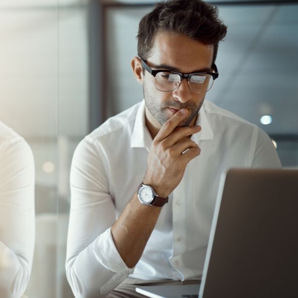 Man looking thoughtfully at a computer