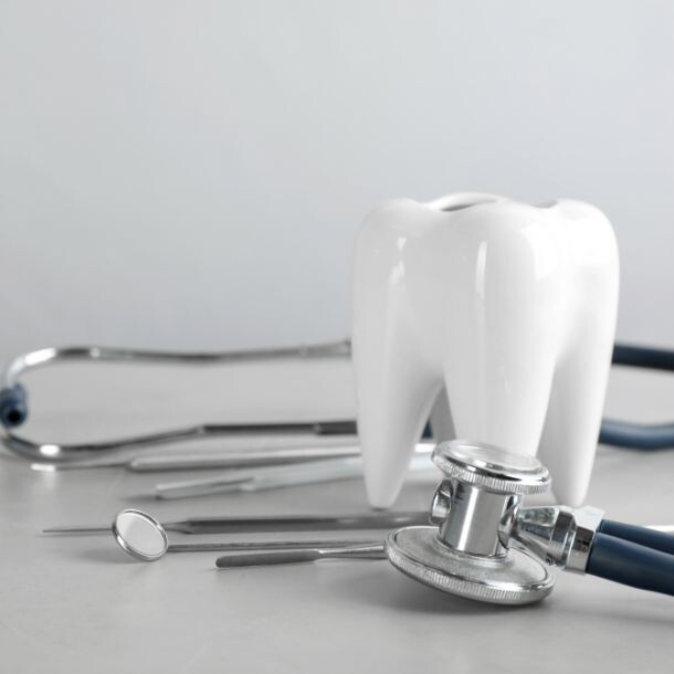 Large tooth-shaped support with a stethoscope around it.