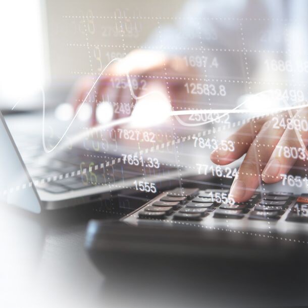Hands typing on a keyboard, image is slightly blurred