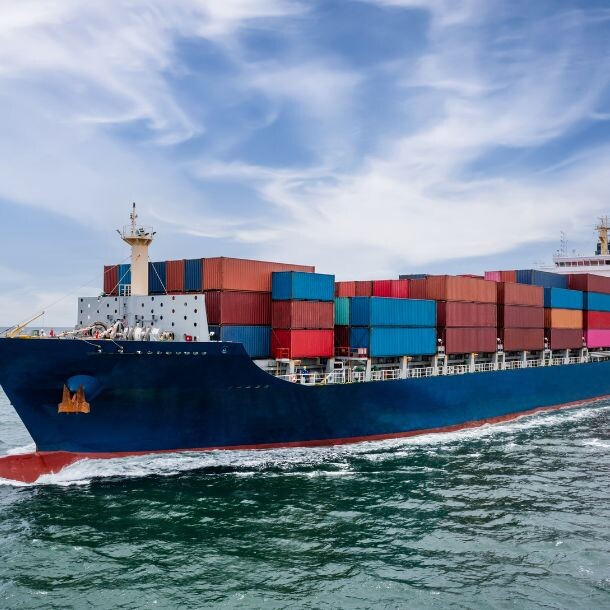 A large transportation ship carrying metal containers.