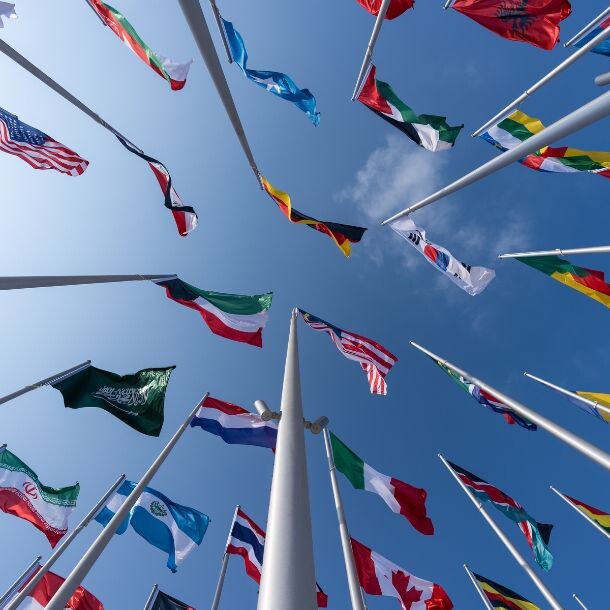 A shot from the ground up of many countries' flags.