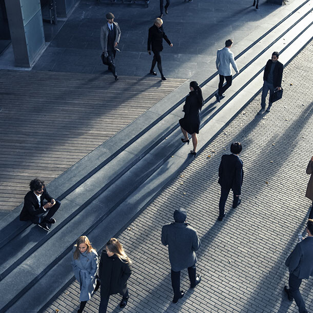 Overhead view of people walking through a city business district plaza