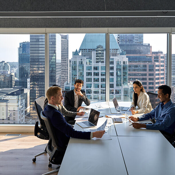 Diverse executive team discussing financial results in a modern meeting room.