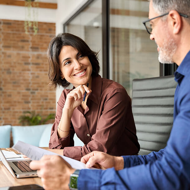 Professionals discussing financial documents at a meeting table.