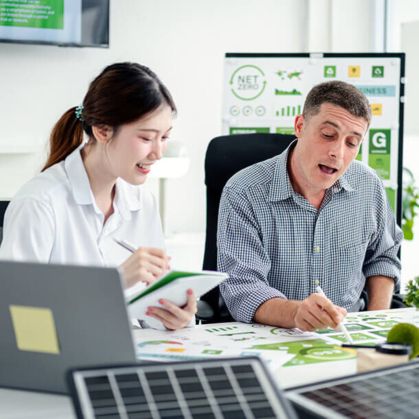 Business professionals analyze environmental social governance data focusing on sustainability.